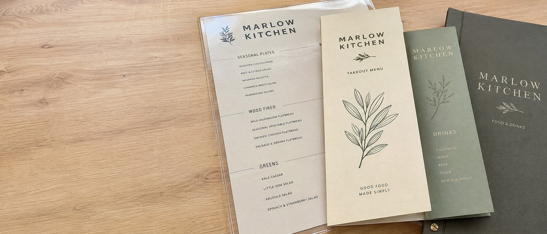 Custom printed menus with a logo fanned out on a restaurant table